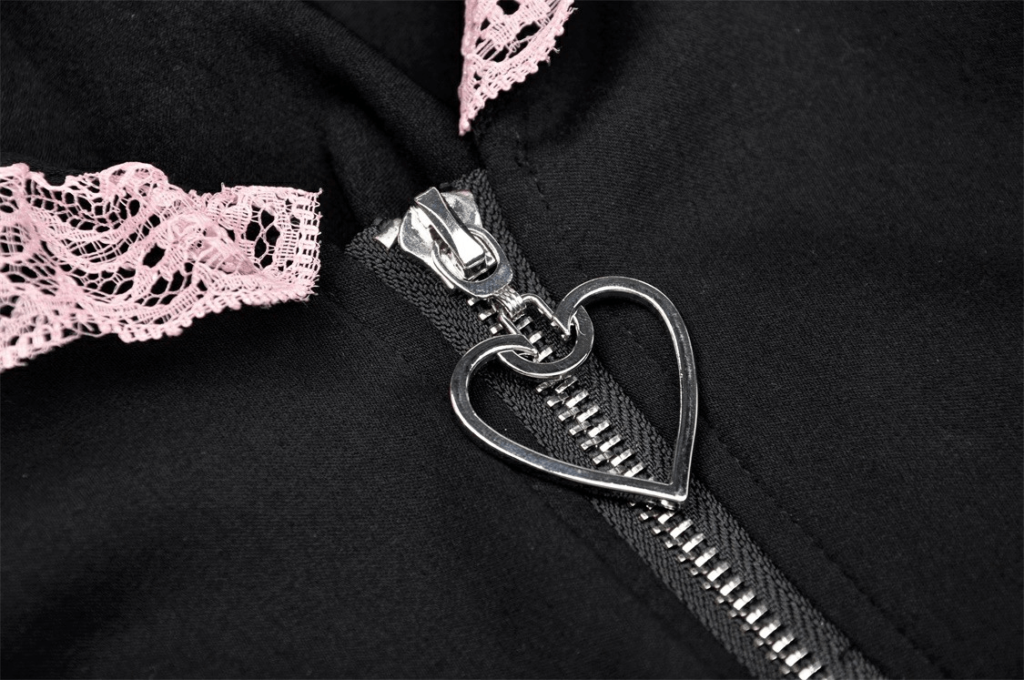 Close-up of black crop top zipper with heart charm and pink lace collar detail, perfect for a cute feline-inspired outfit.