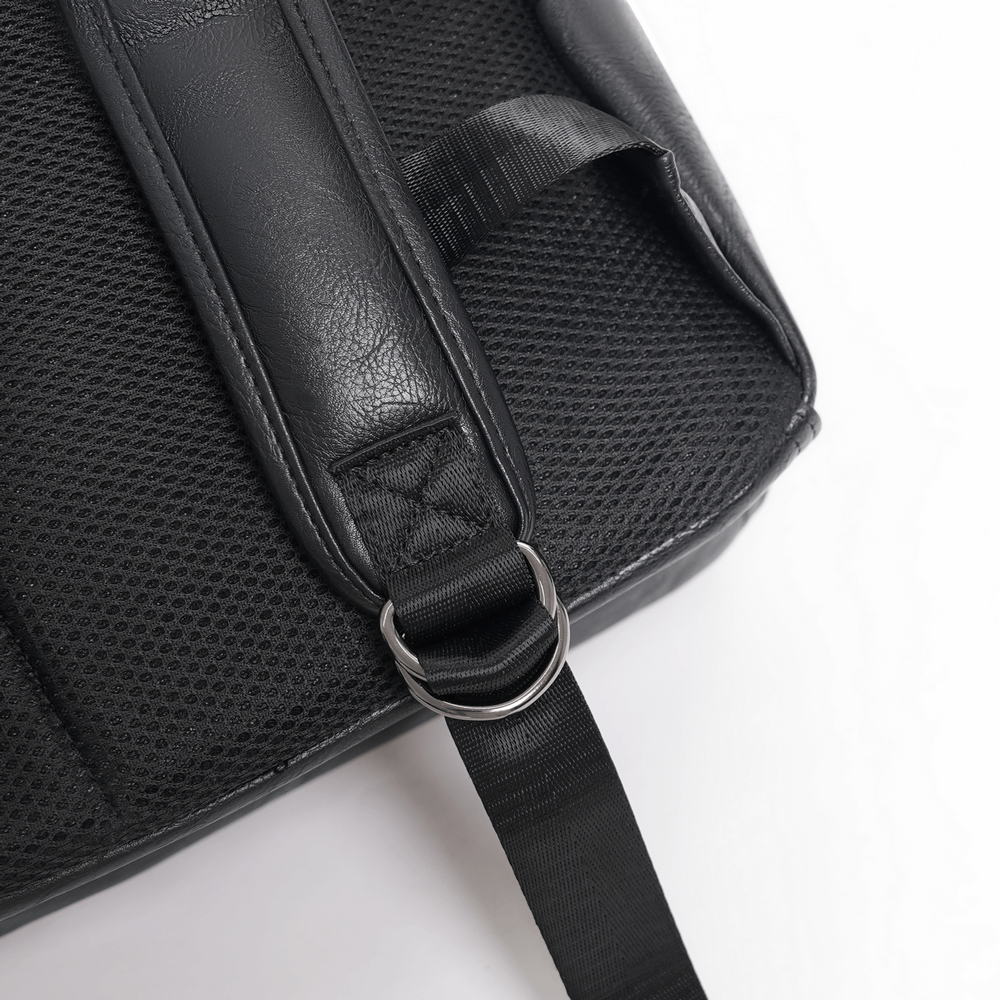 Close-up of black gothic backpack strap detailing with mesh and metal ring for added style and durability.