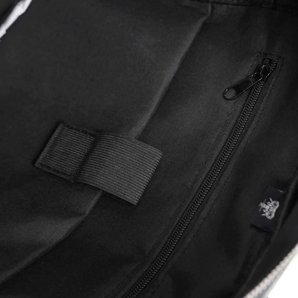 interior view of a black backpack showing zip pocket and compartment for organized storage and style.