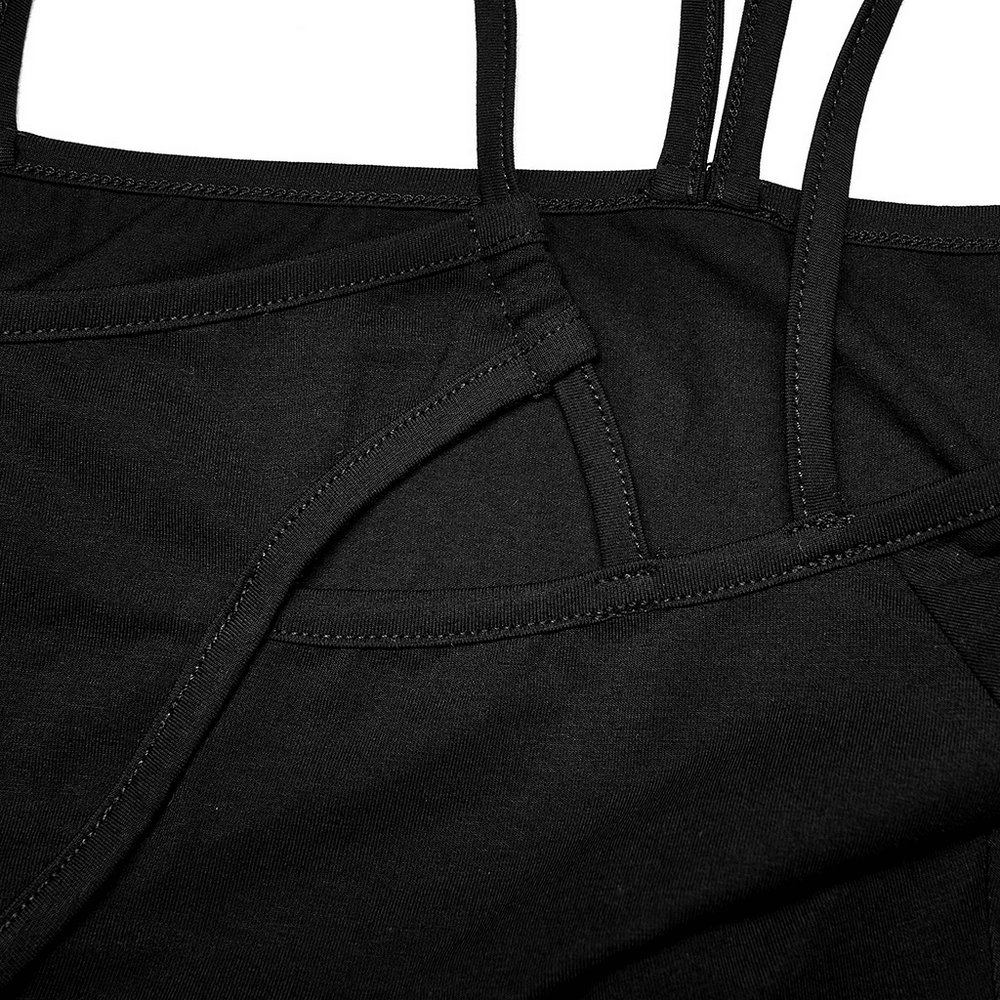 Close-up of black bodysuit straps highlighting delicate stitching and unique cross design.