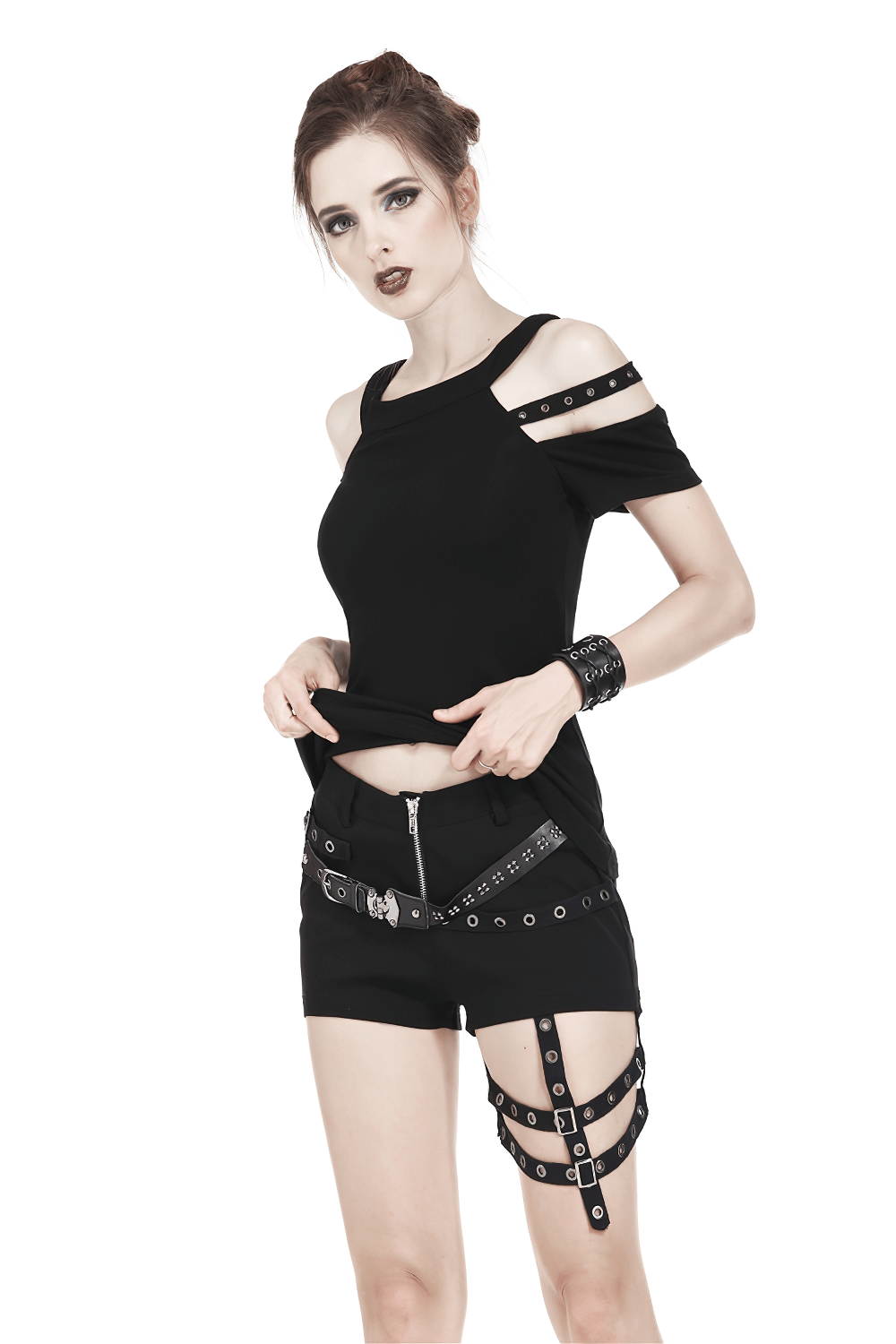 Gothic black cold shoulder top with studded straps, paired with edgy shorts and accessories for a punk rock style.
