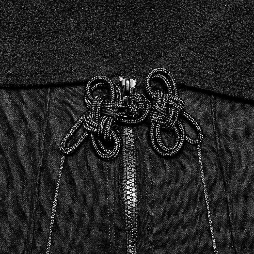 Close-up of black cropped hoodie with unique zipper and intricate lace-up details. Perfect gothic fashion statement.