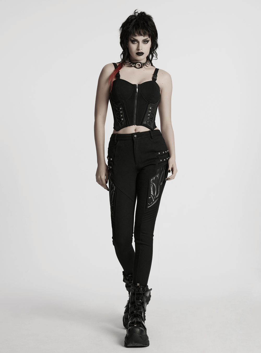Model showcasing a black cyberpunk corset waistcoat with buckle straps, paired with edgy black pants.