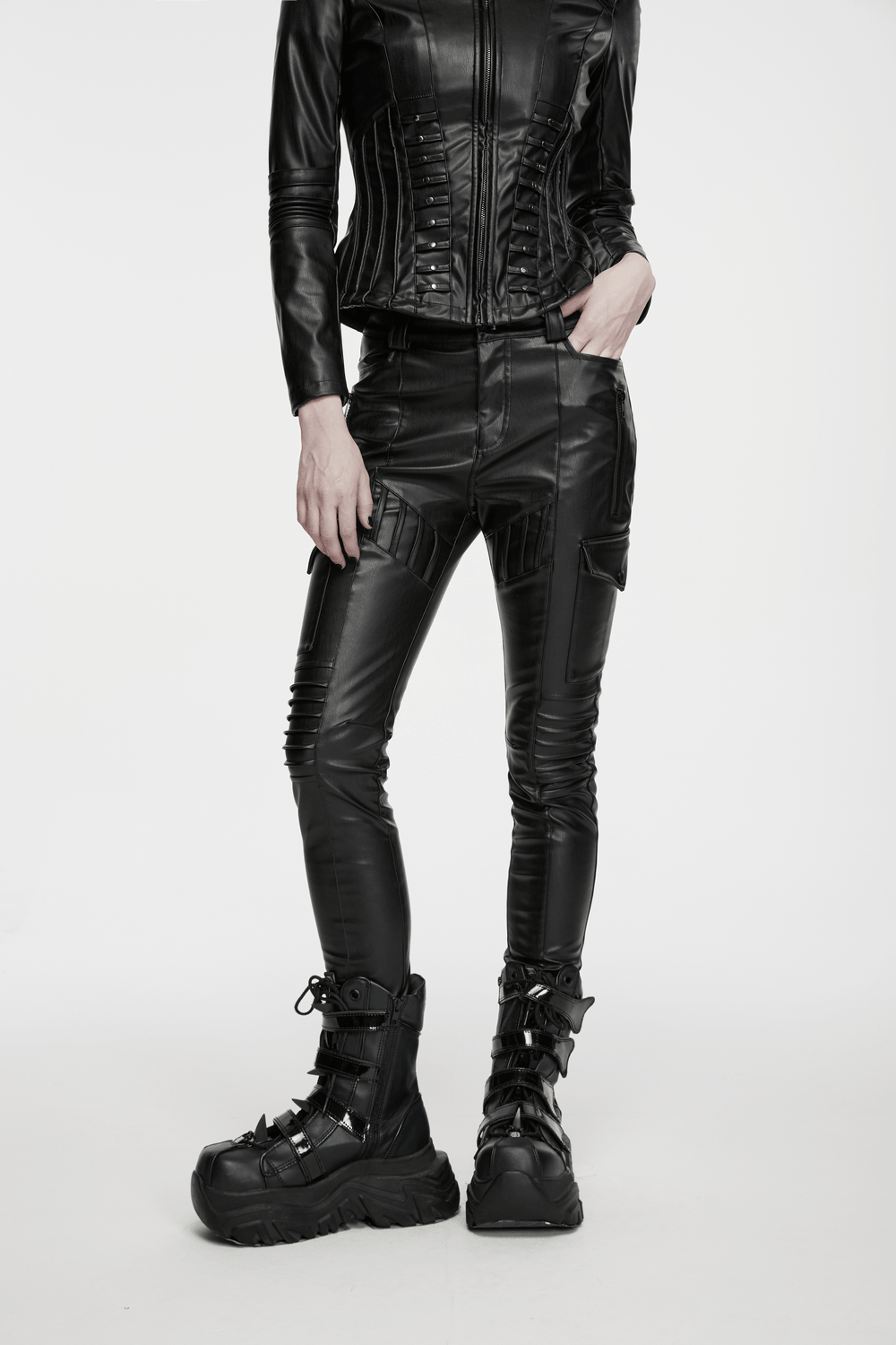 Model wearing Black Cyberpunk Slim Cargo Pants with Pleated Panels and stylish black boots, posing dynamically.
