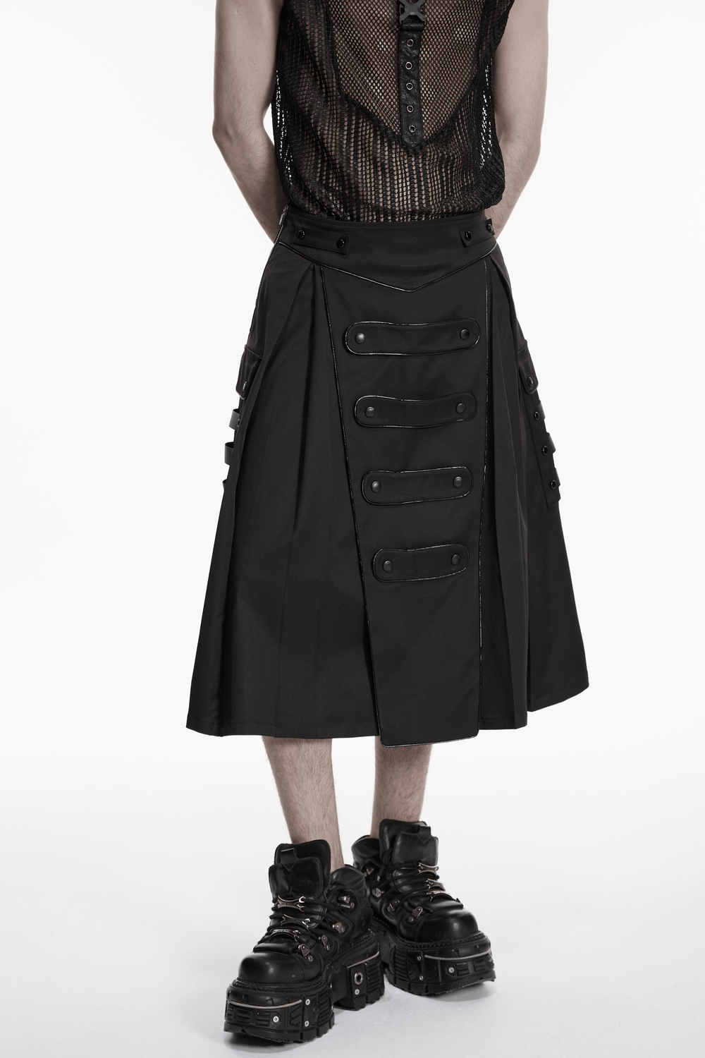 Black Cyberpunk Utility Skirt with Strap Panels for Men worn with bold chunky boots.