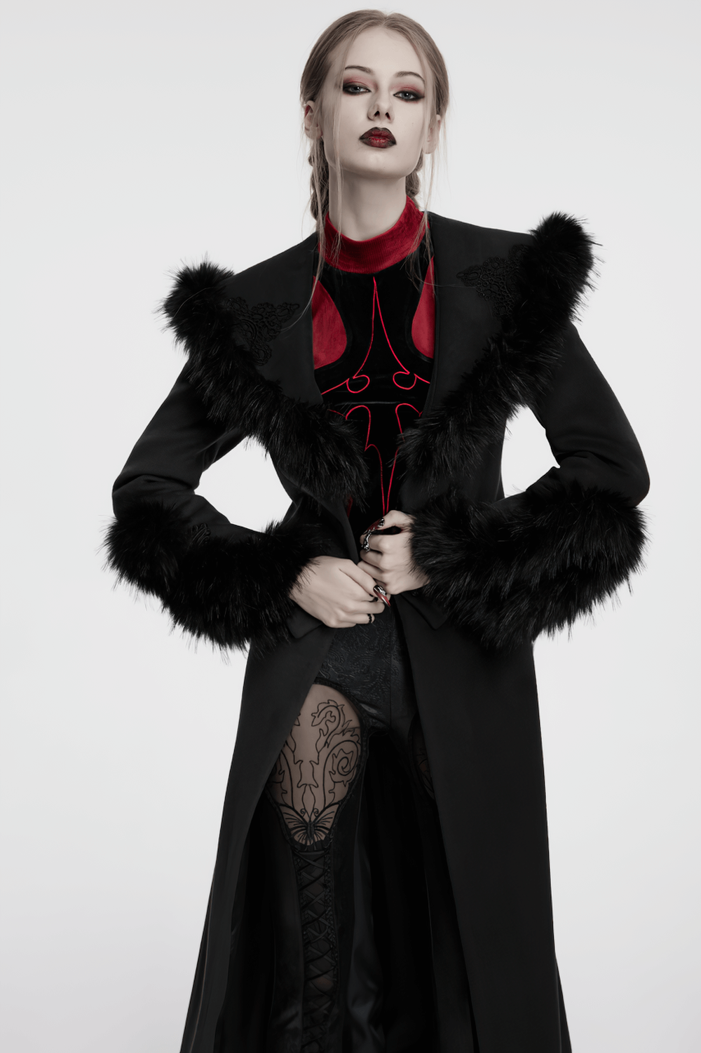 Model in a black detachable two-piece coat with fur collar and vintage buckles, exuding gothic elegance.