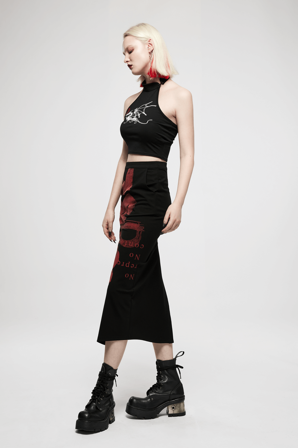 Black dragon print asymmetric skirt with chains, paired with a cropped top and chunky boots for a dark punk style look.