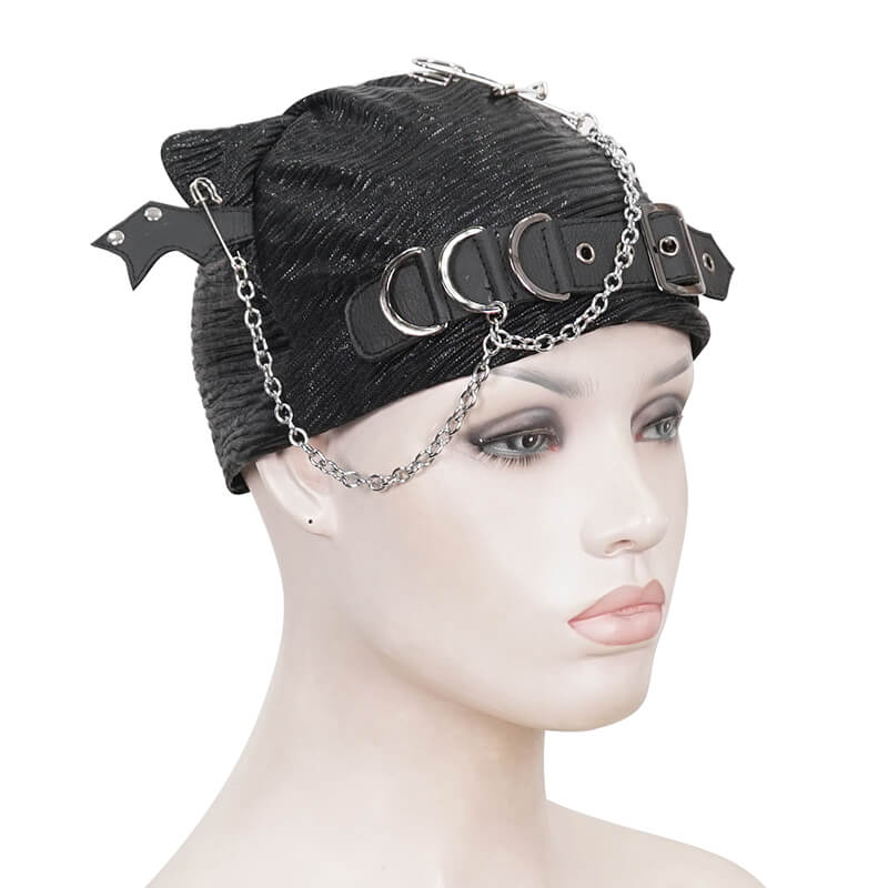 Black gothic batwing buckle hat with chains and pins on mannequin head, edgy punk style accessory.