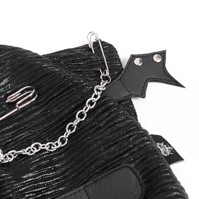 Close-up of a black batwing buckle hat featuring chains, pins, and edgy gothic design elements.