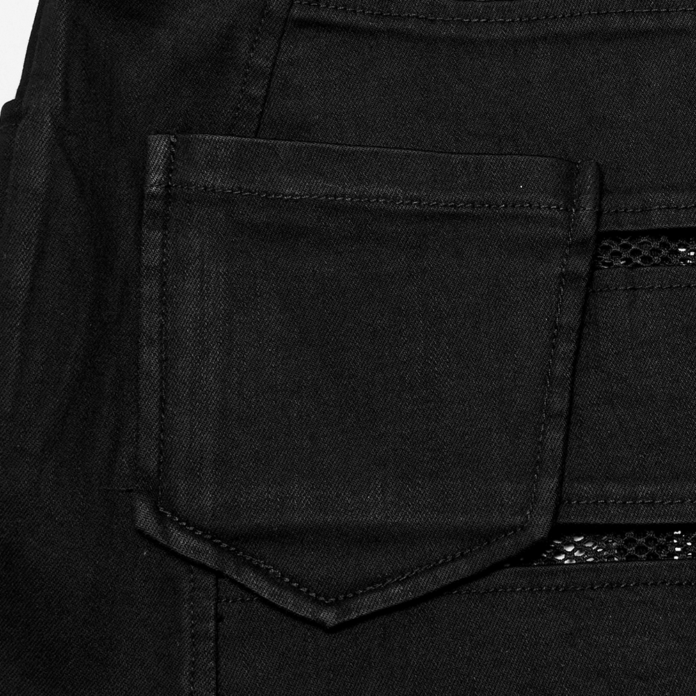 Close-up of black denim mini skirt pocket and edgy mesh panel highlighting punk rock style.