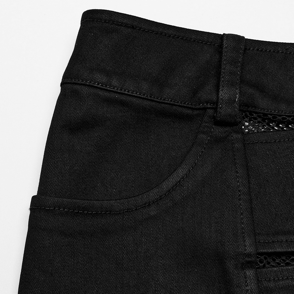 Close-up of black edgy elastic denim mini skirt with diamond mesh panels and stylish pockets.