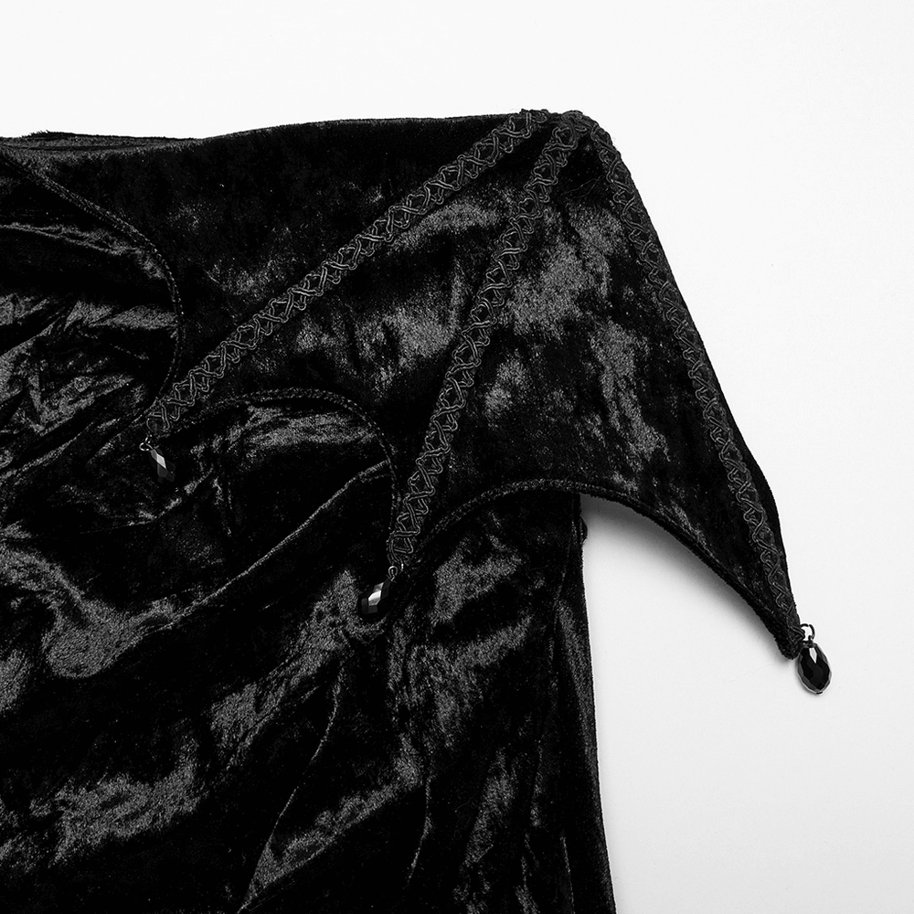 Close-up of black velvet lace asymmetrical skirt featuring pointed waistband and intricate lace detailing.