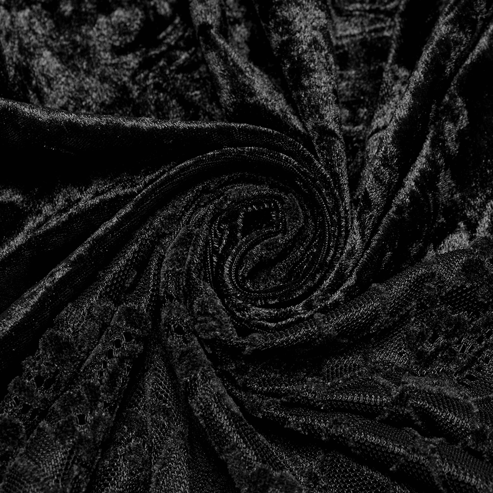 Close-up of luxurious black velvet fabric with intricate lace detailing, perfect for elegant fashion designs.