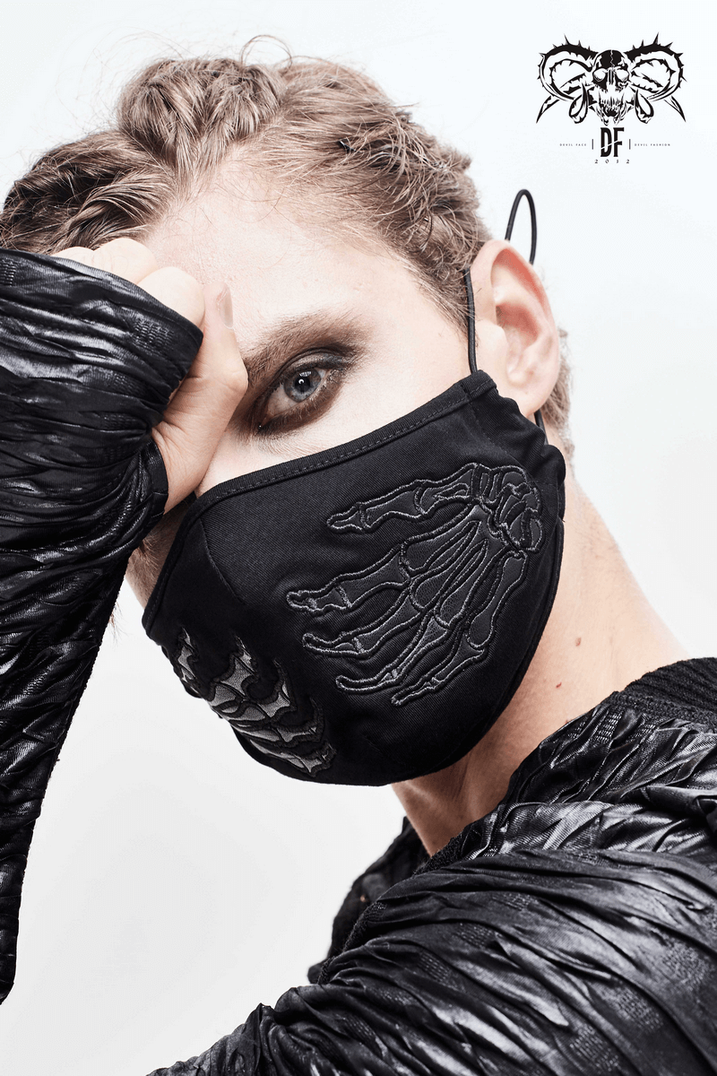 Unisex gothic black skeleton face mask with adjustable straps, stylishly worn by a model.