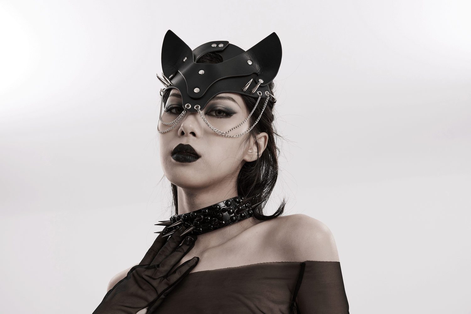 Stylish punk black faux leather fox mask with studs and chains, showcasing bold elegance and edgy fashion.