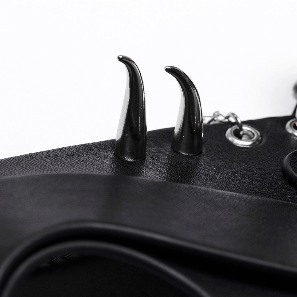 Close-up of sleek black faux leather fox mask with sharp horns and chains, perfect for a punk aesthetic.