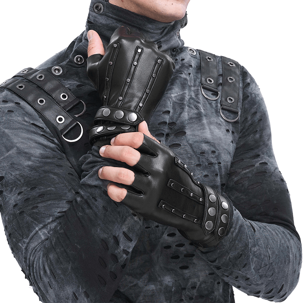 Close-up of a man wearing black faux leather motorcycle gloves with protective studs, showcasing rugged style.