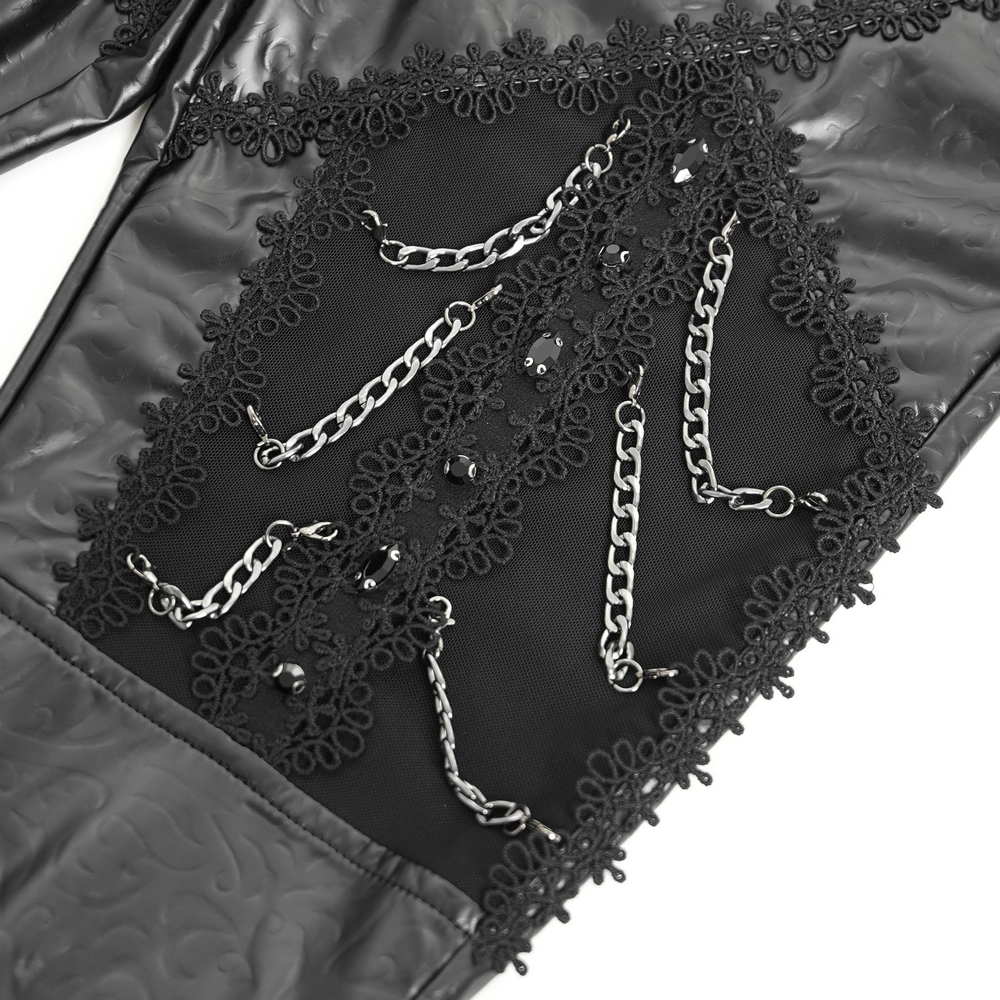 Close-up of black faux leather pants showcasing chain and sequin embellishments for a gothic style.