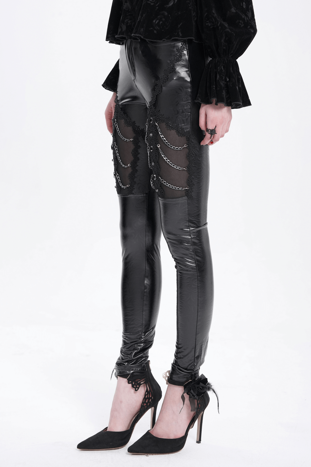 Black faux leather pants with chains and sequins, showcasing an edgy, goth-inspired style for alternative fashion lovers.