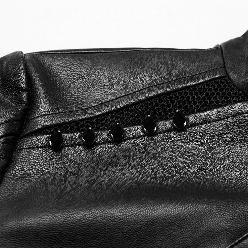 Close-up of black faux leather punk jacket featuring mesh and studded spikes for an edgy look.