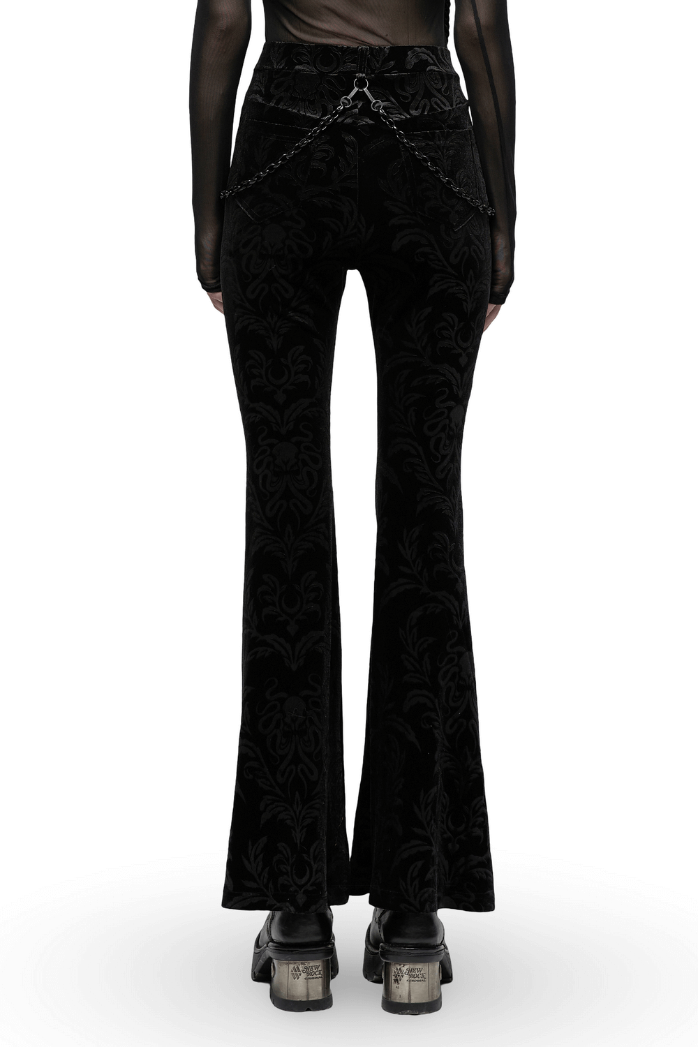 Back view of black floral velvet flared pants with chains and mesh waist, showcasing gothic style and dramatic flare.