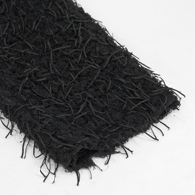 Close-up of the textured fluffy black fabric of a punk-style off-shoulder irregular sweater.