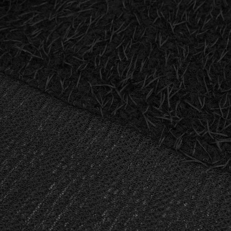 Close-up of black fluffy off-shoulder irregular sweater showcasing its textured fabric and unique design.