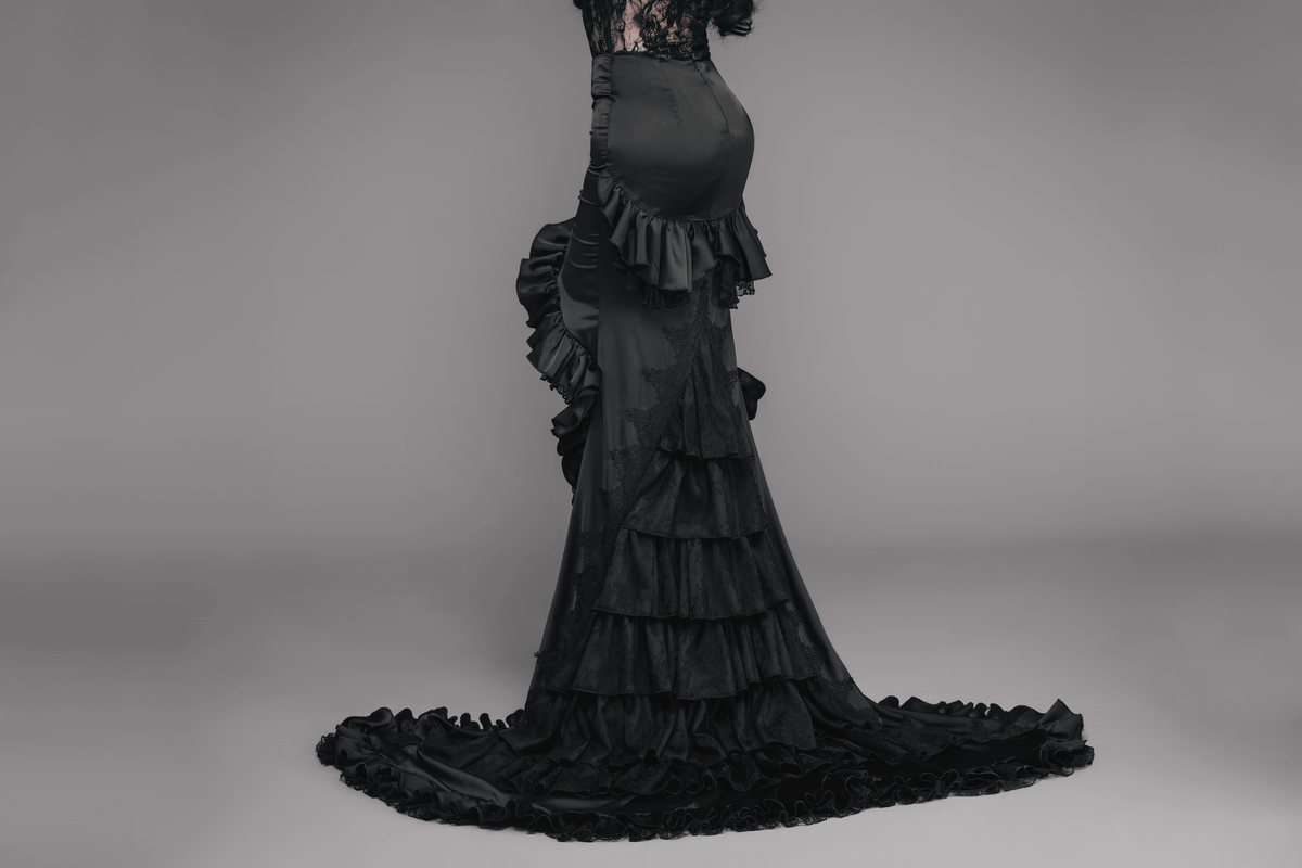 Black frilled gothic skirt with long train and lace detailing showcasing elegant vintage design.