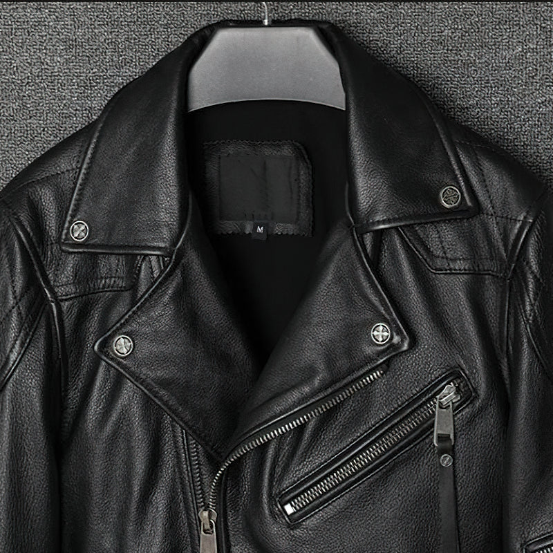 Detail of a black genuine leather biker jacket featuring zippers and classic rock style.