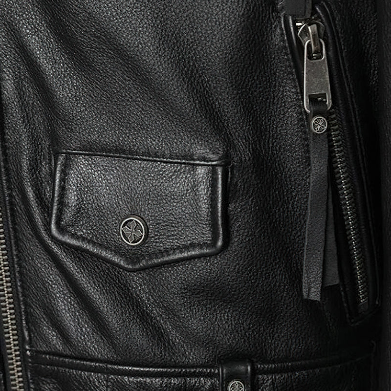 Close-up of a stylish black genuine leather biker jacket with zippered pockets and unique detailing.