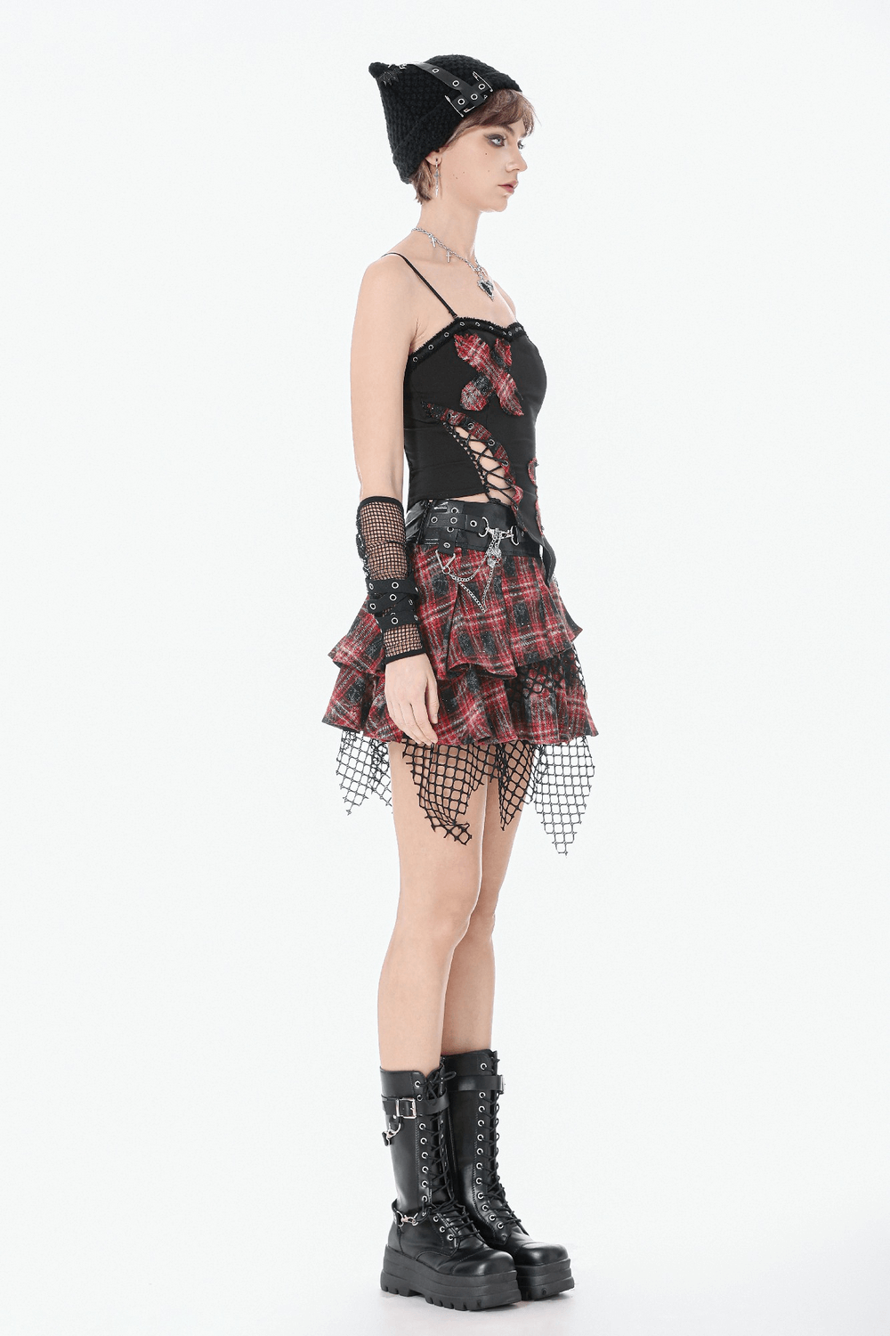 Black Goth Punk Plaid Patch Top with Side Lace Up styled with a plaid skirt and fishnets, showcasing an edgy and bold look.
