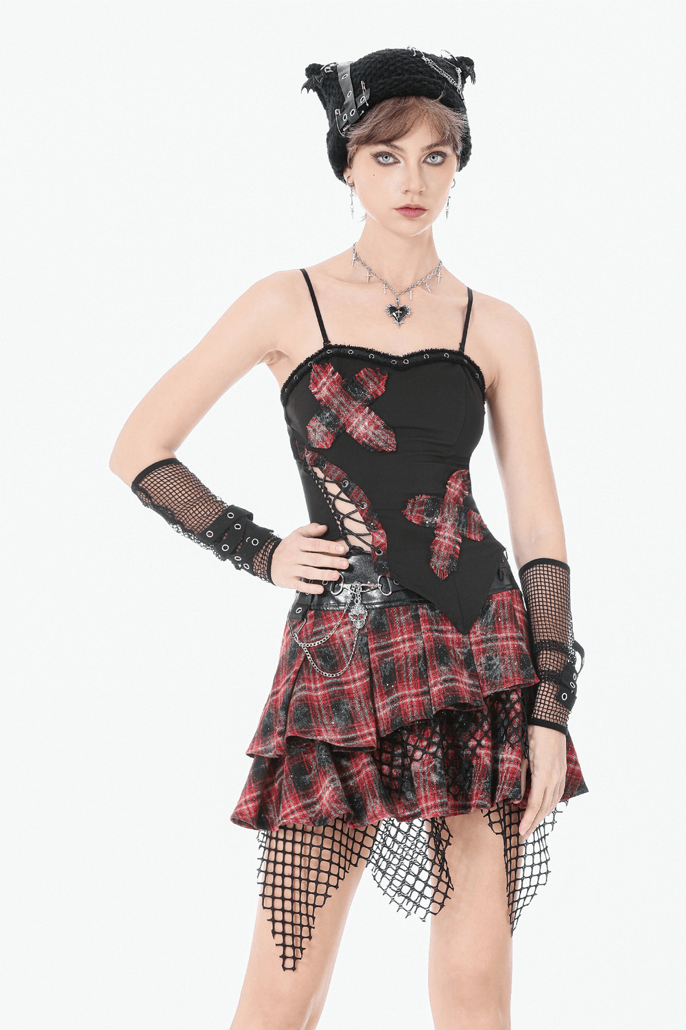 Black Goth Punk Plaid Patch Top with Side Lace Up worn with a stylish plaid skirt and accessories, showcasing a daring look.