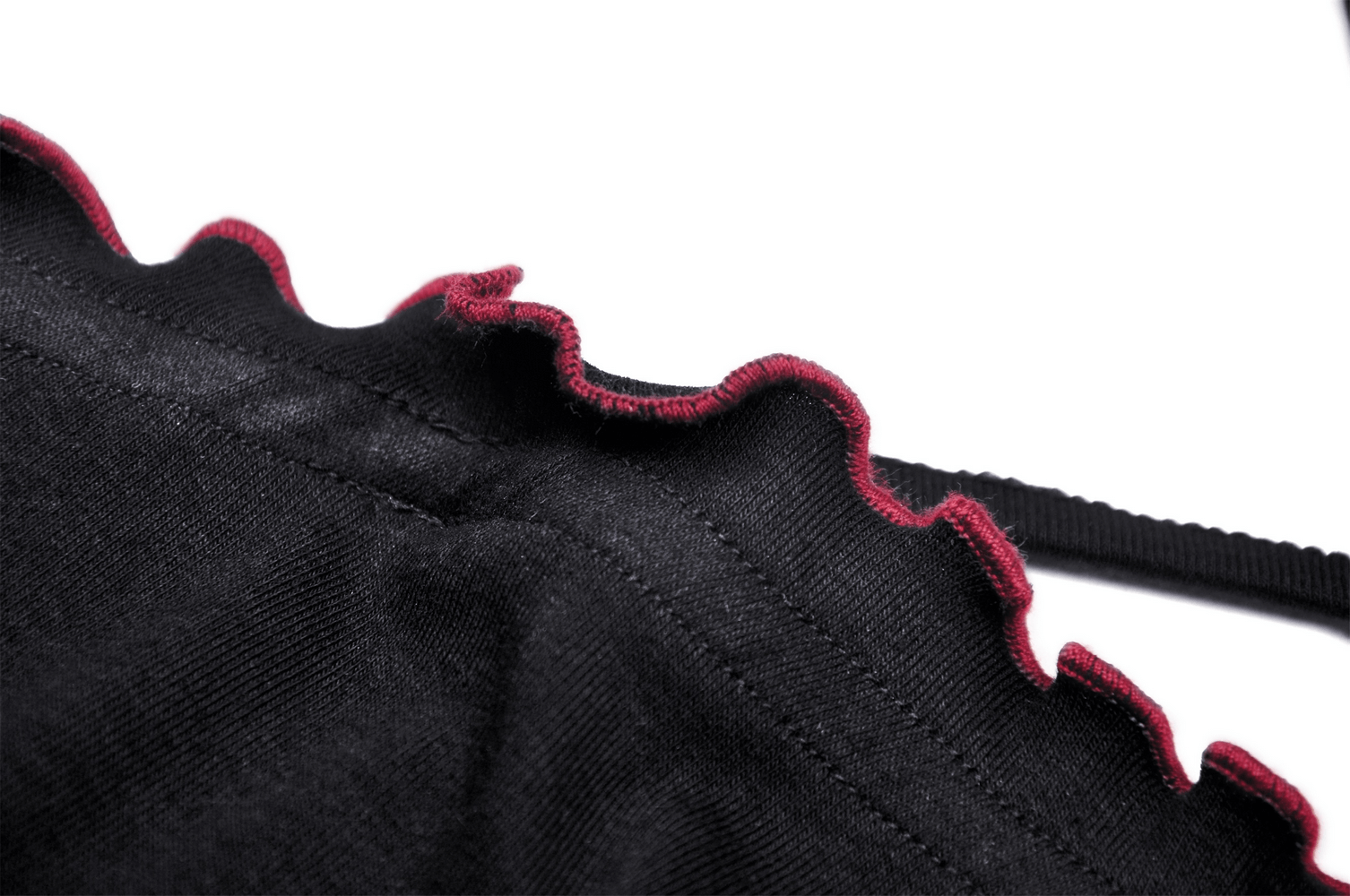 Close-up of the ruffled edge on a black gothic crop top with a striking red detail.