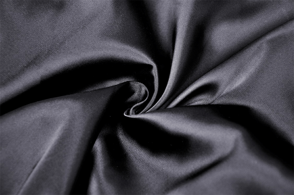 Luxurious black chiffon fabric suitable for gothic-inspired fashion, showcasing a smooth, flowing texture.