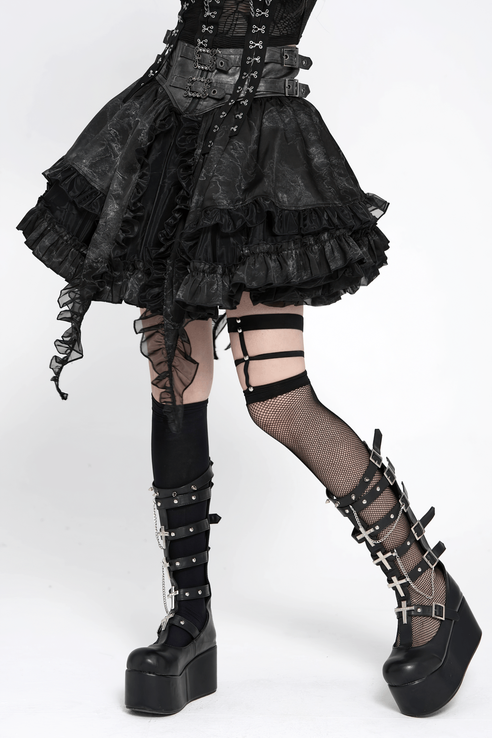 Black Gothic Corset Ruffle Mini Skirt with Chains worn with edgy platform shoes and layered tights, showcasing punk style.
