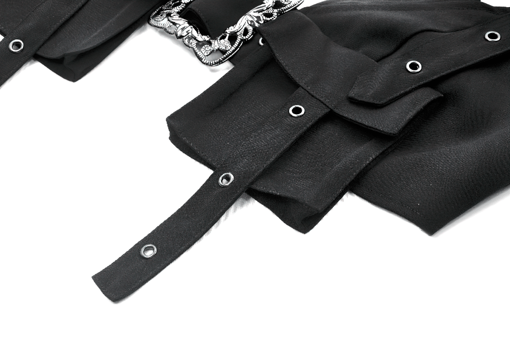 Close-up of black gothic crop top with buckles and grommet detailing, showcasing the ornate metal accents.
