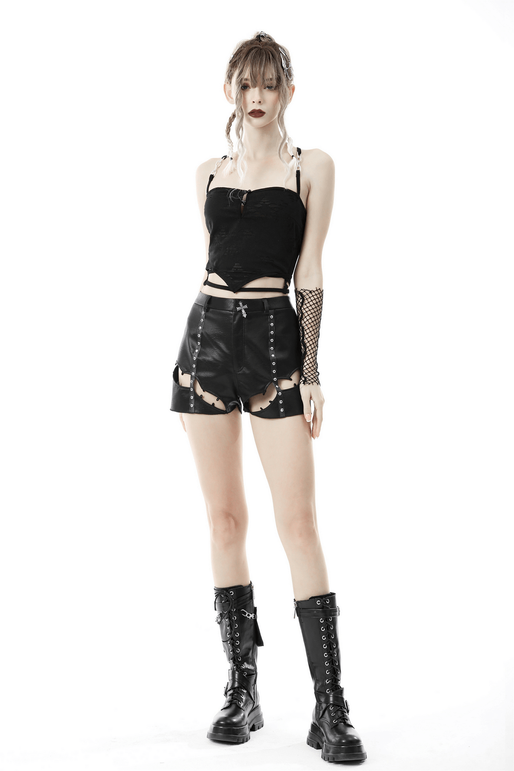 Black gothic crop top with chain detail straps, paired with ripped shorts and combat boots for a bold, edgy look.