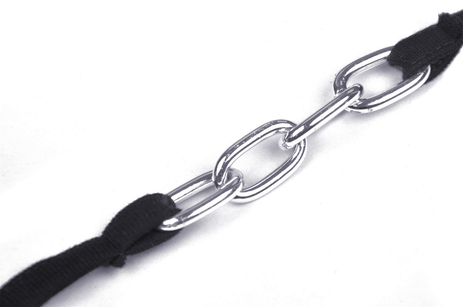 Close-up of black crop top chain strap, showcasing edgy silver links and soft fabric for gothic fashion.
