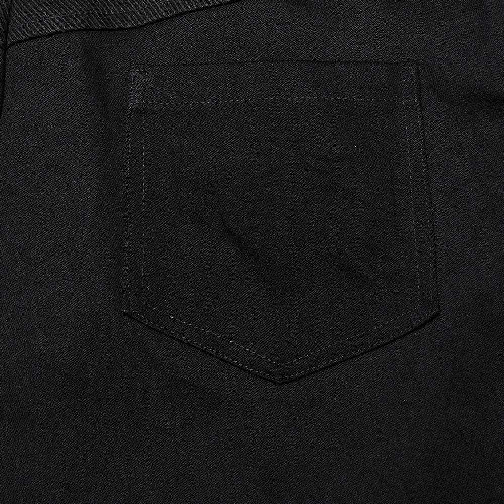 Close-up of black denim pocket showcasing sleek, gothic style and minimalist design.