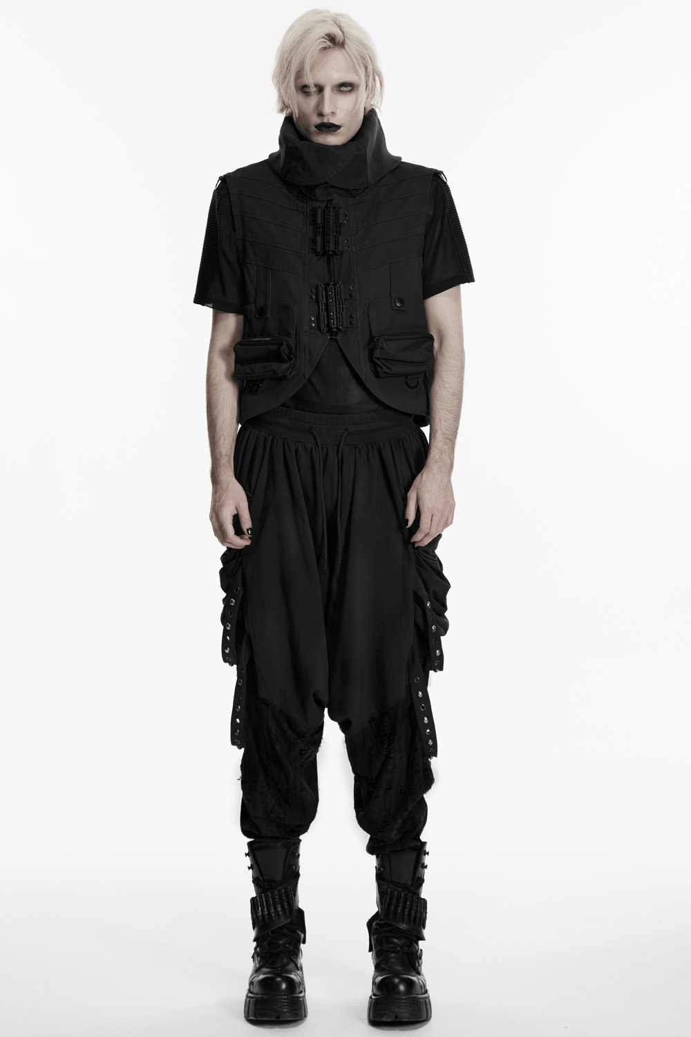 Black Gothic Drop-Crotch Pants with Studded Pockets worn with a black vest and combat boots in a dramatic pose.