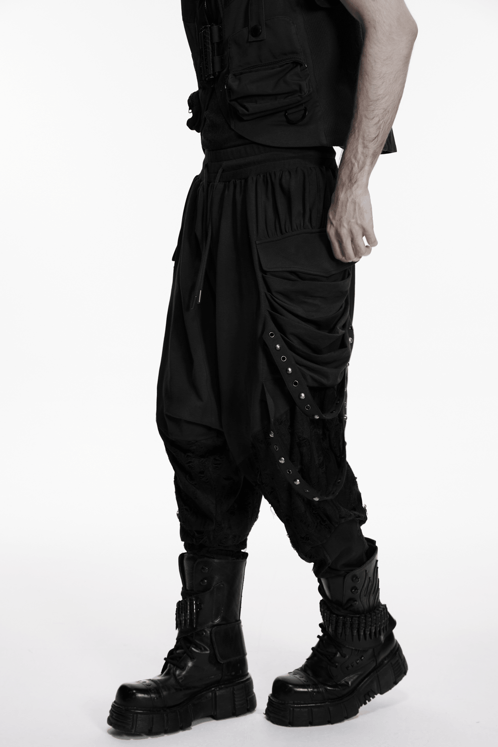 Black Gothic Drop-Crotch Pants with Studded Pockets styled with combat boots, showcasing a rebellious, edgy silhouette.