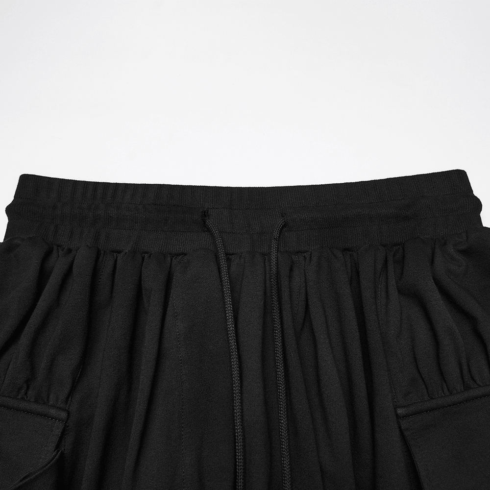 Black Gothic Drop-Crotch Pants with Studded Pockets featuring elastic waistband and drawstrings.