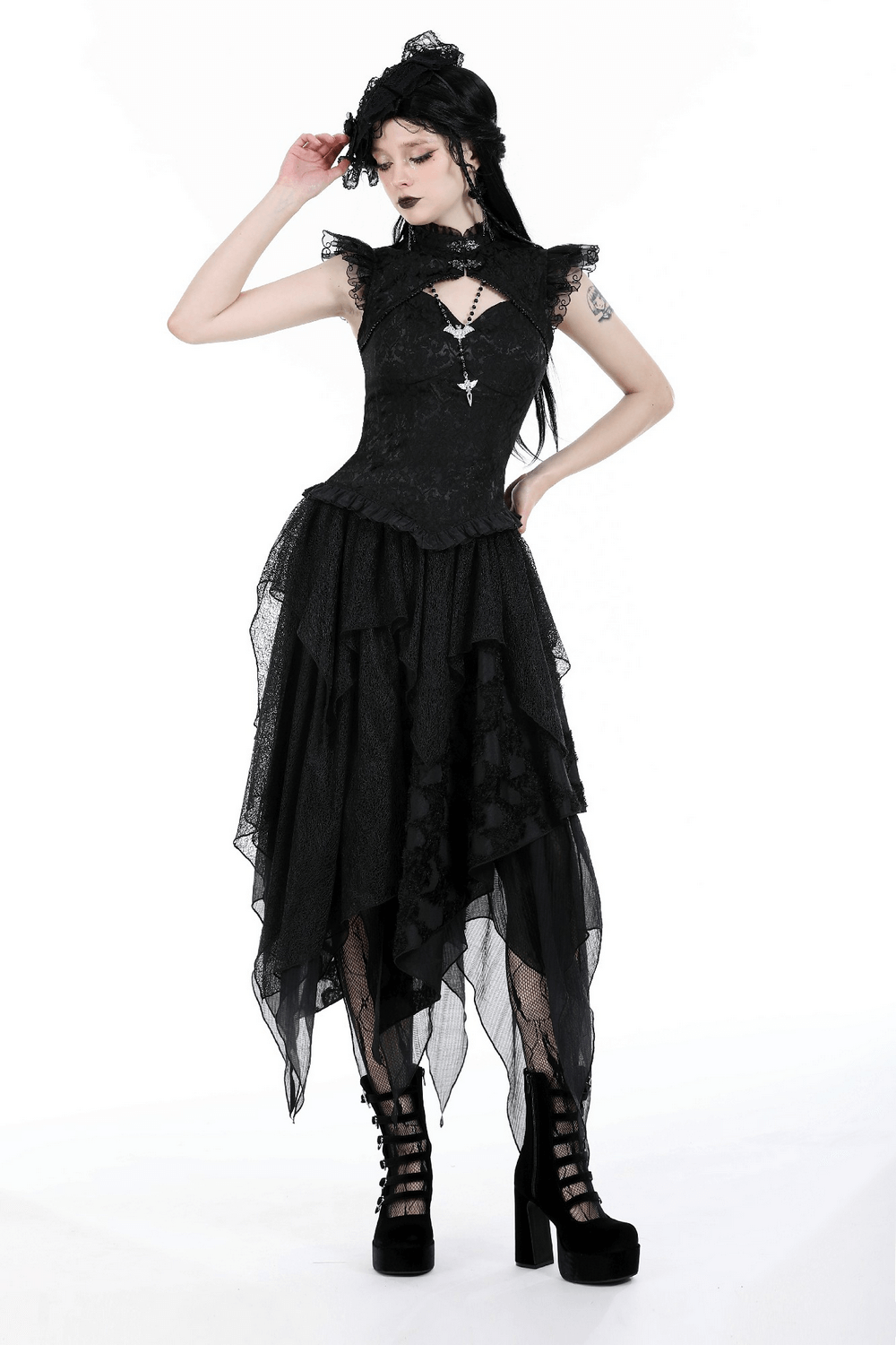 Gothic black lace top with cascading ruffles and dramatic sleeves, styled with high-waisted skirt and platform shoes.