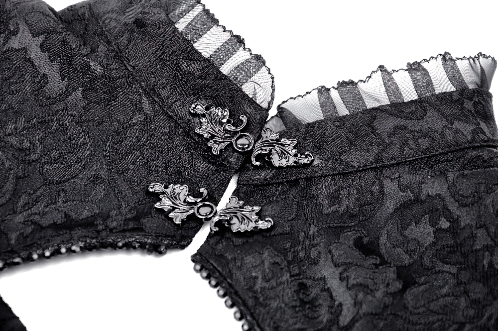 Elegant black gothic lace top details with ornate buttons and textured fabric. Perfect for a dramatic fashion statement.