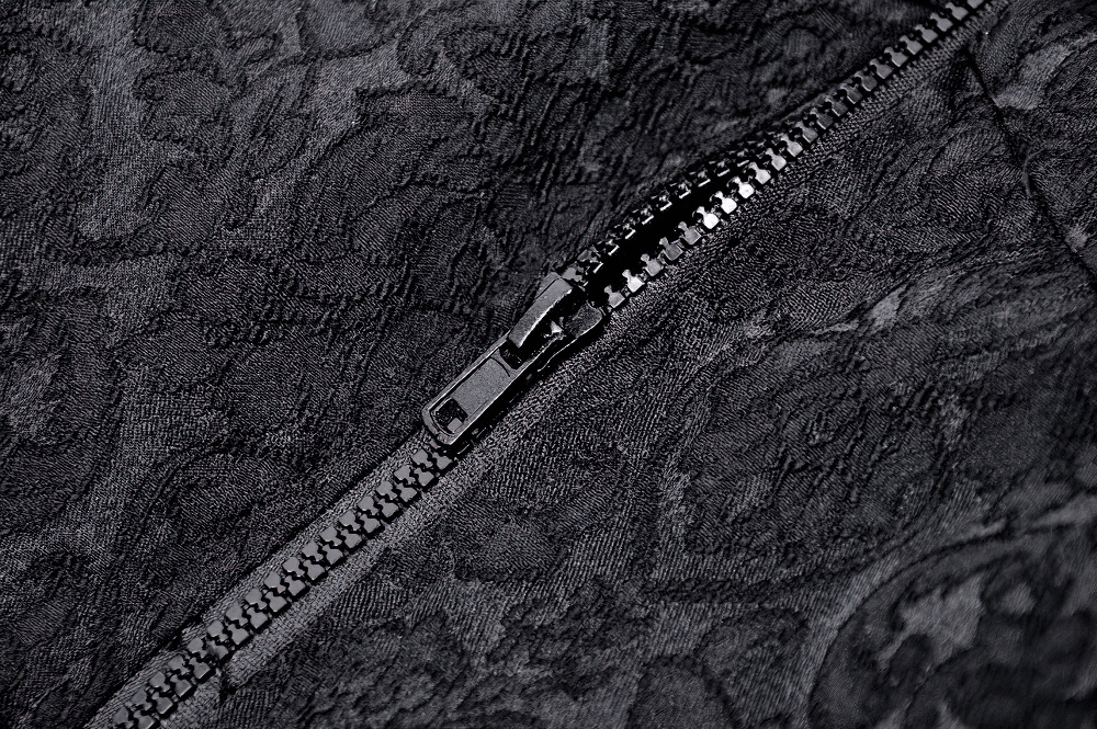 Close-up of black lace fabric with zip detail, perfect for gothic style fashion and dramatic textures.