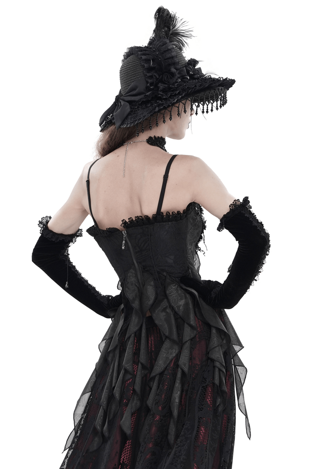 Alt Tag: Black Gothic Floral Lace-Up Corset Bustier Top styled with feathered witch hat, sheer ruffled handkerchief hem, and lace gloves, back view