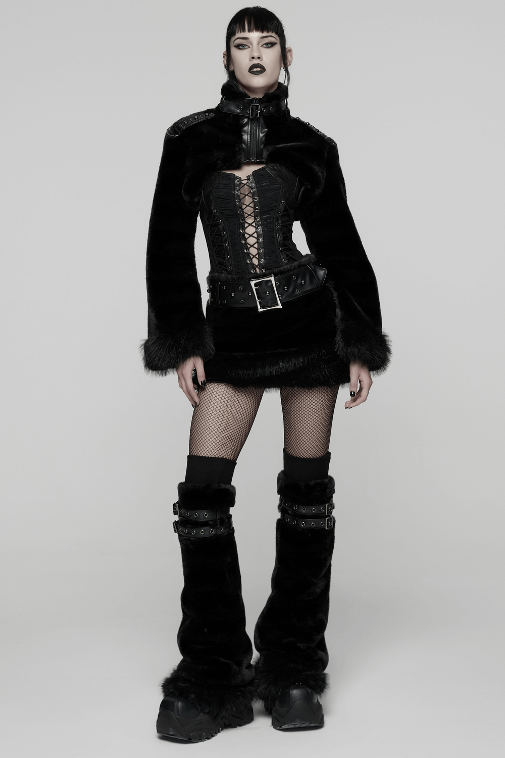 Black Gothic Fur Leg Warmers with Buckle Straps and Trim styled with a matching edgy outfit in a studio setting.
