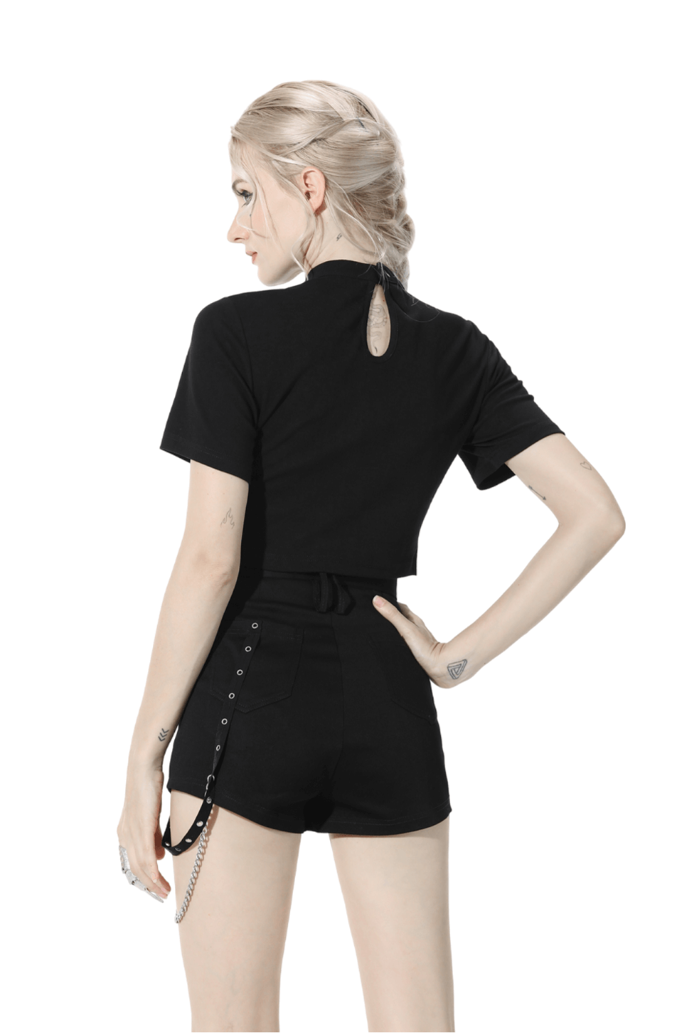 Back view of a model in a black gothic halter crop top with chain detail, paired with stylish high-waisted shorts.
