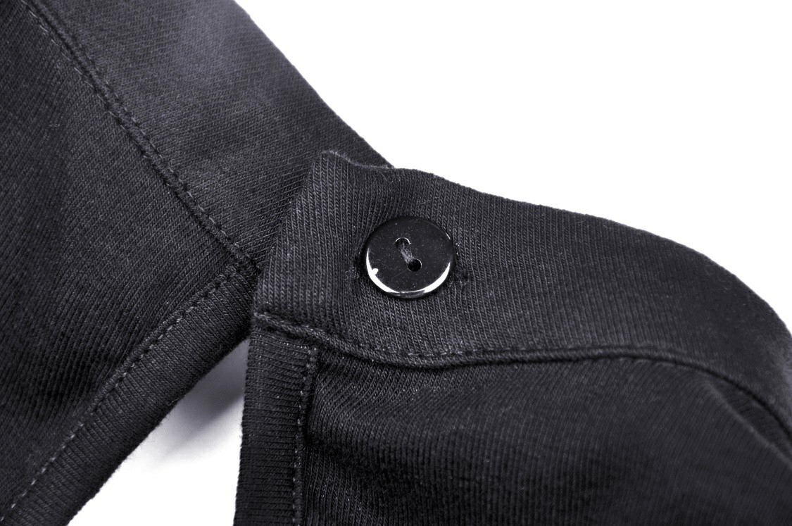 Close-up of the button detail on a black gothic halter crop top with chain accents.