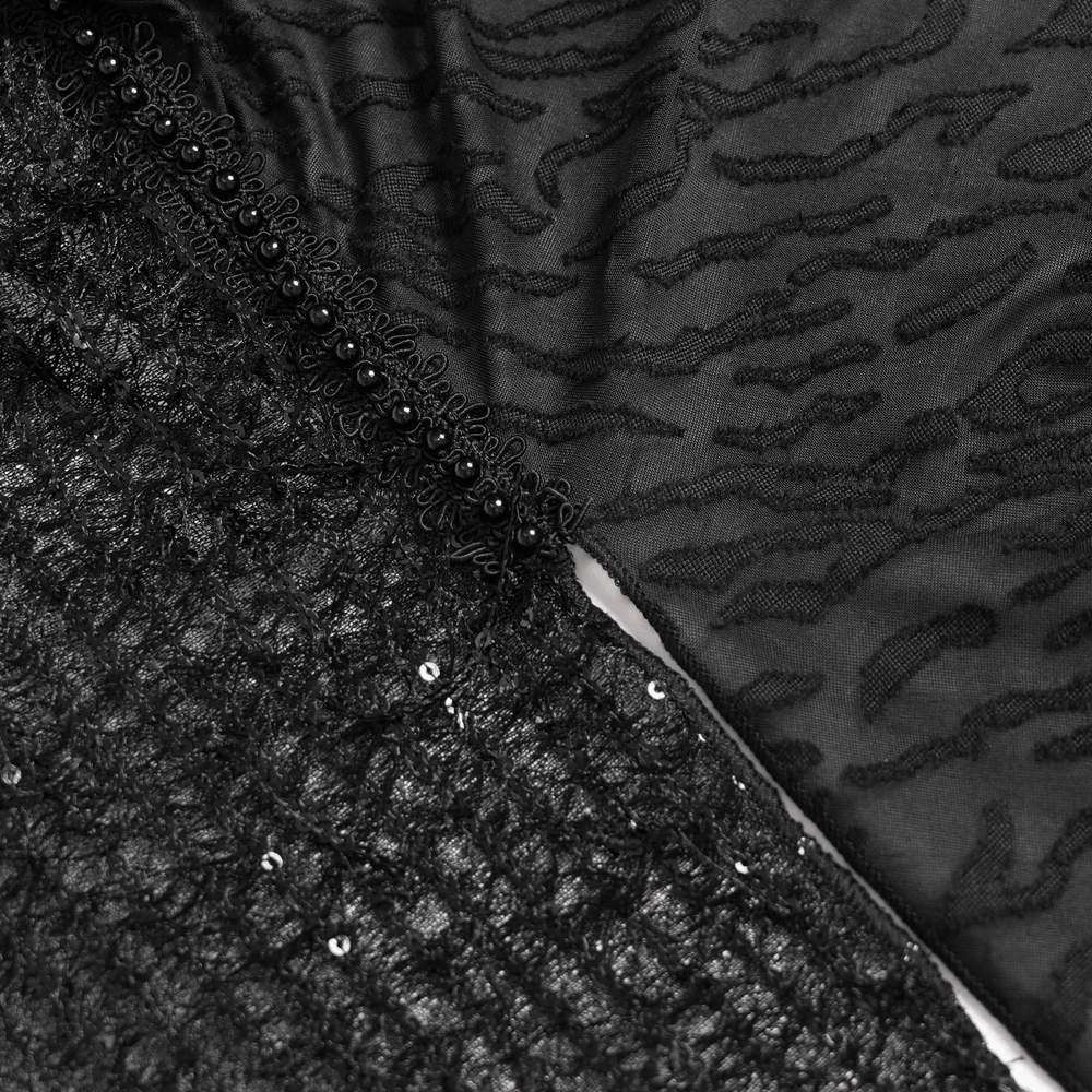 Alt Tag: Black Gothic Halter Neck Top with Asymmetric Hemline close-up of distressed mesh, animal-print fabric and beaded trim